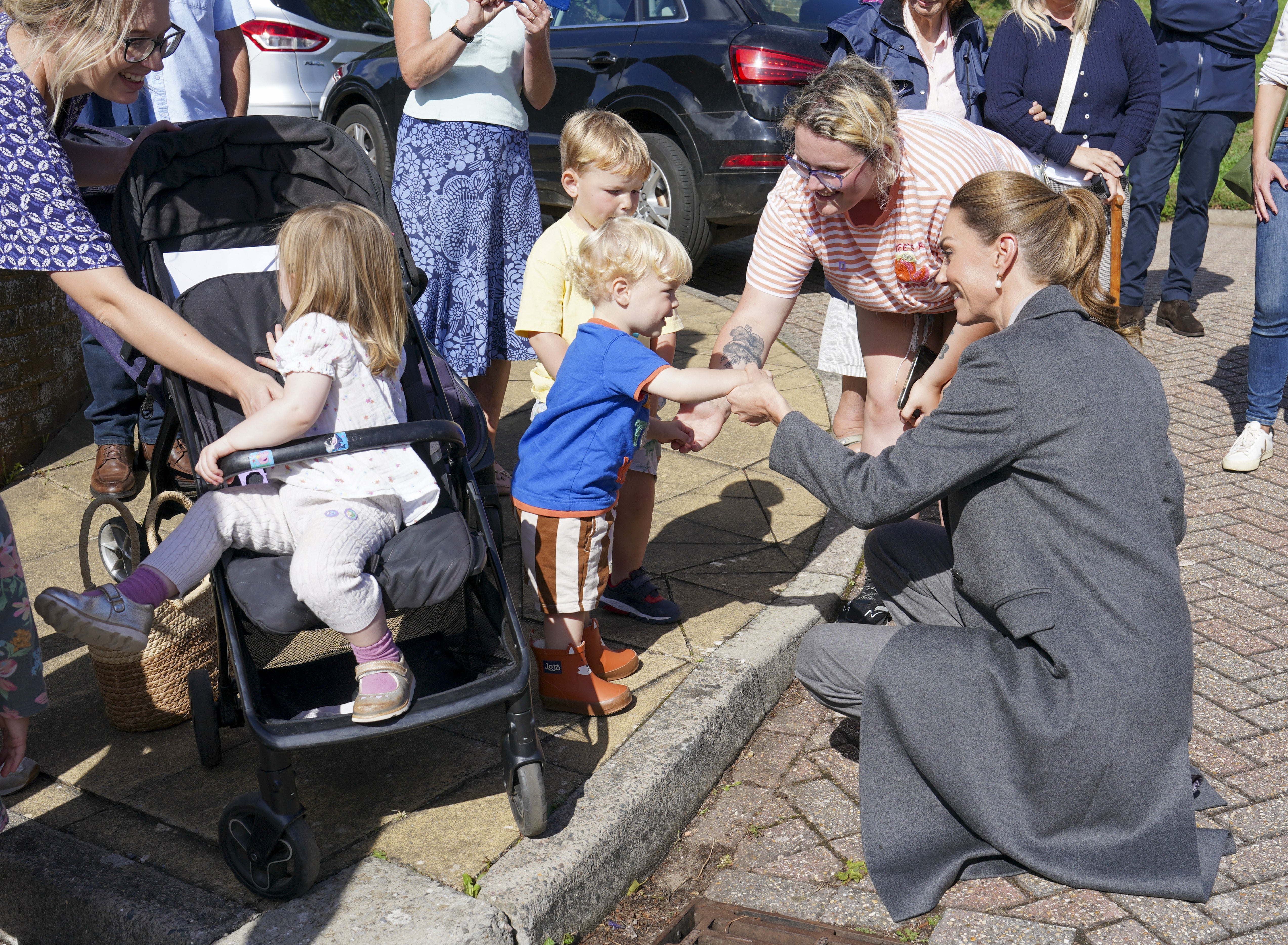 Kate helps one-year-old Albie Botley-Greenslade jump from a kerb in Pulborough, West Sussex